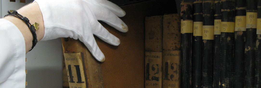 photo of person taking book off shelf